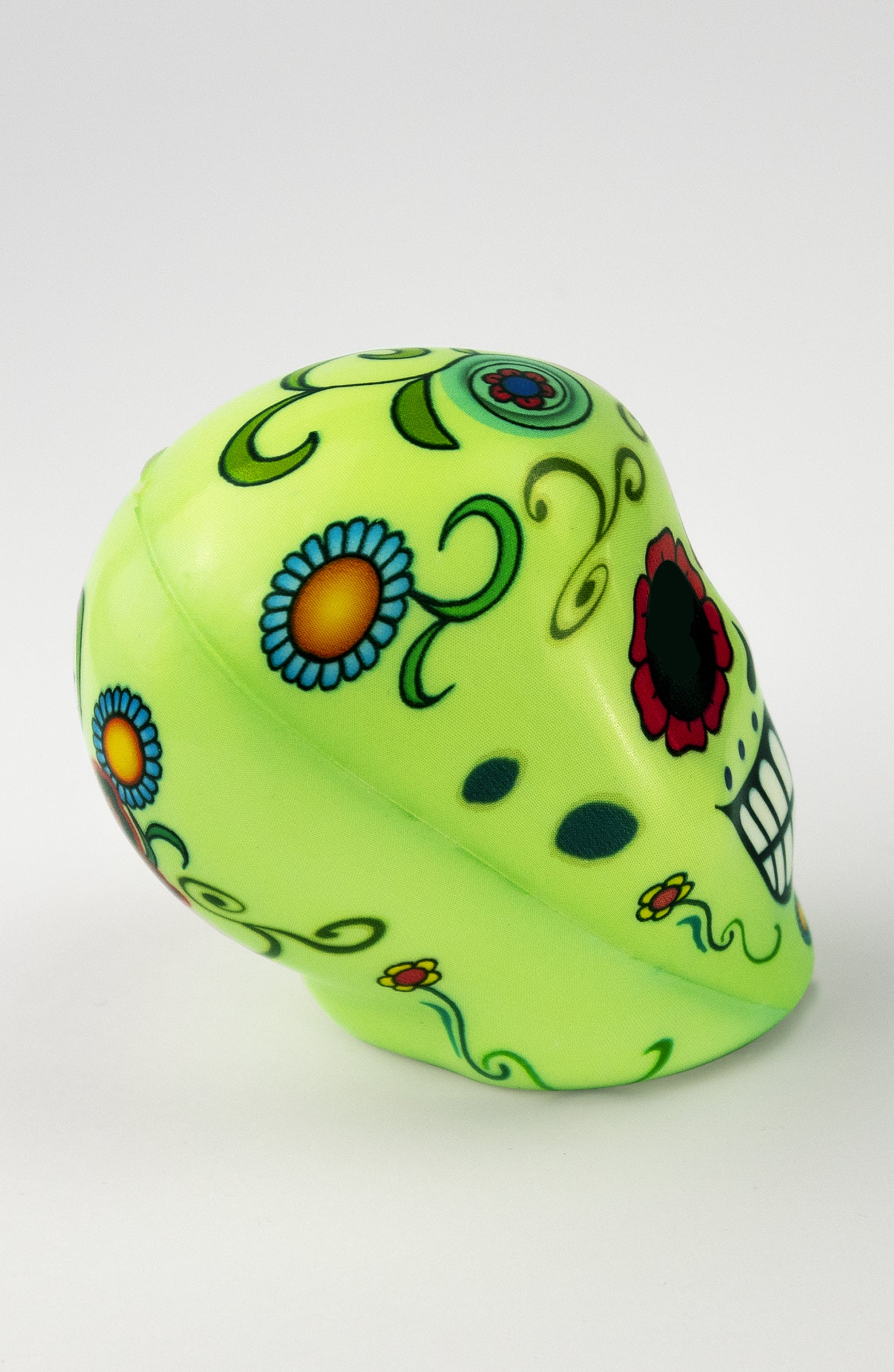 Pallina Antistress a forma di teschio verde con decorazioni floreali